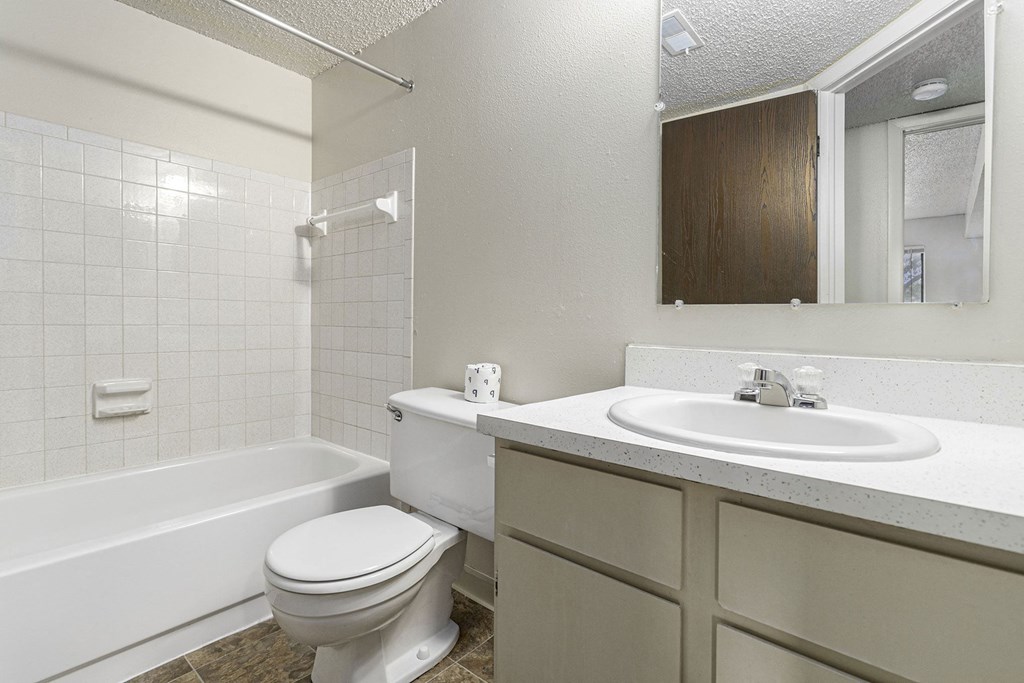 a bathroom with a sink toilet and a bath tub at Briarwood Apartments, Benton Harbor, MI