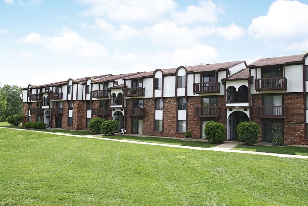 brick apartment building with a green lawn at Brookside Apartments in Springfield, MI