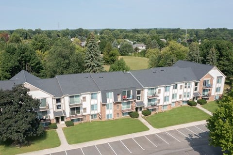 A large building with a parking lot in front of it.
