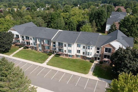 A large building with a parking lot in front of it.