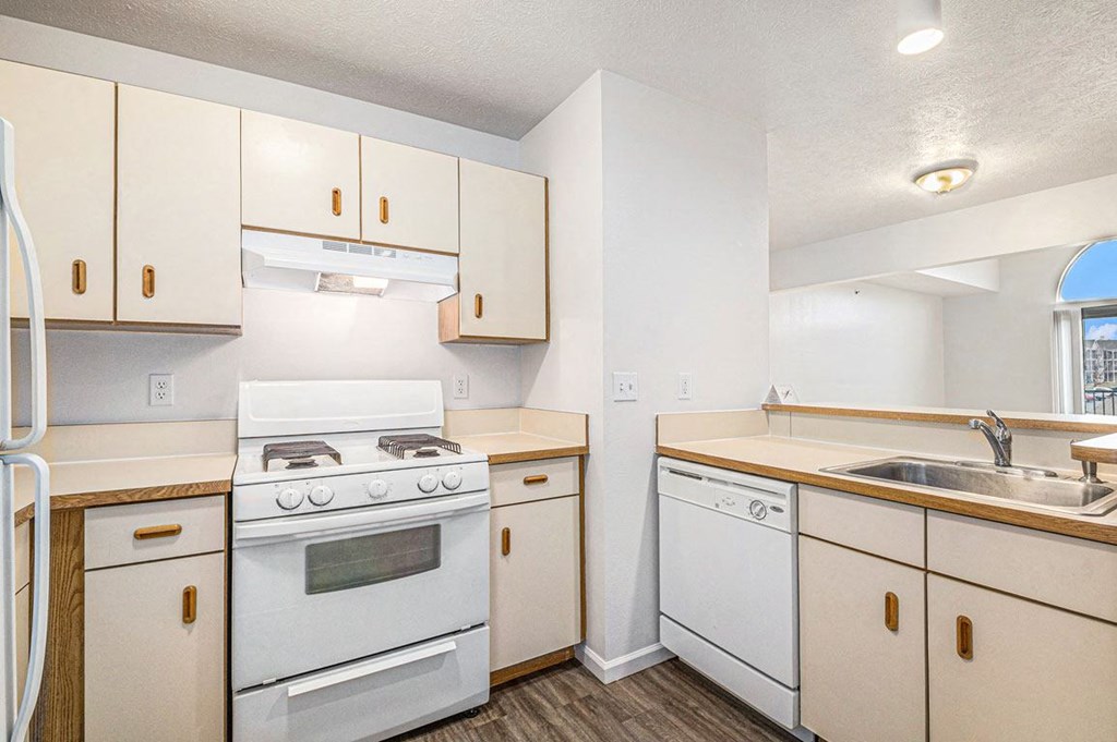 a two bedroom kitchen with white appliances  at Black Sand Apartment Homes, Lincoln, NE