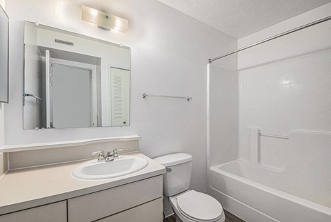 primary bathroom with a sink, toilet and a shower  at Black Sand Apartment Homes, Lincoln, NE