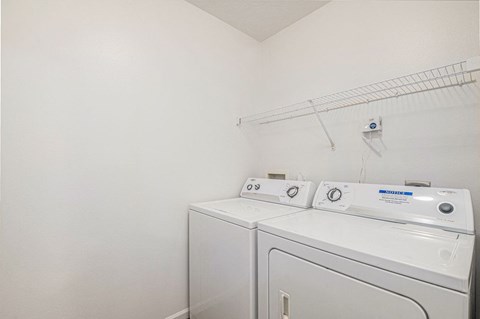 a laundry room with a full size washer and dryer  at Black Sand Apartment Homes, Nebraska