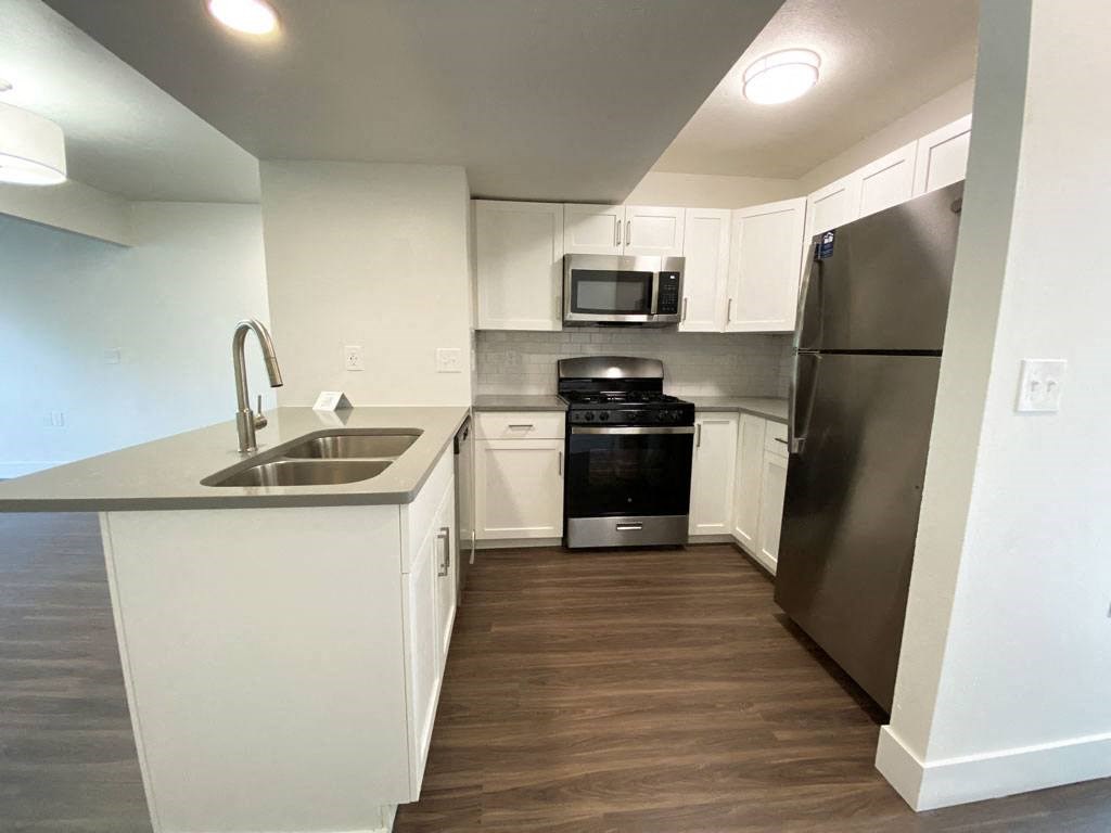 Stylish Kitchen with Breakfast Bar at Byron Lakes Apartments in Byron Center, MI