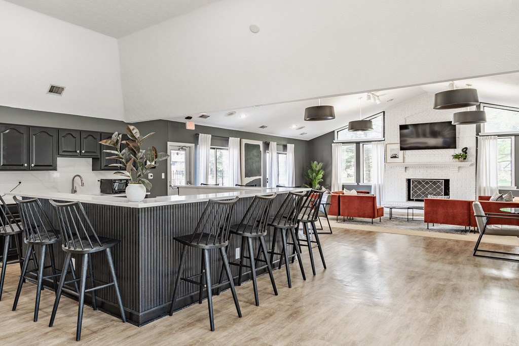 A modern kitchen with a bar area and a fireplace