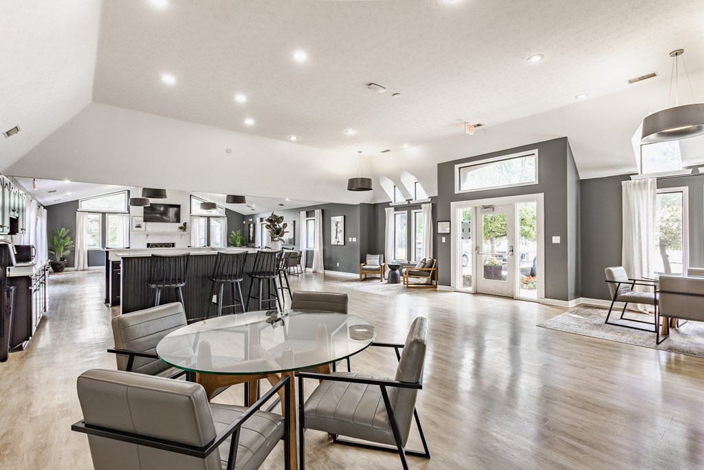 A modern dining room with a glass table and chairs