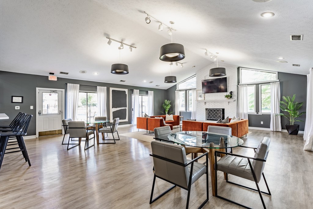 A modern dining room with a glass table and chairs