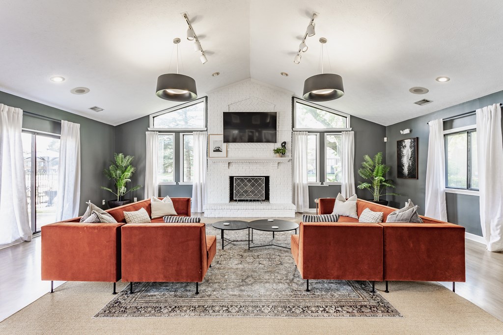 A living room with a fireplace and a television.