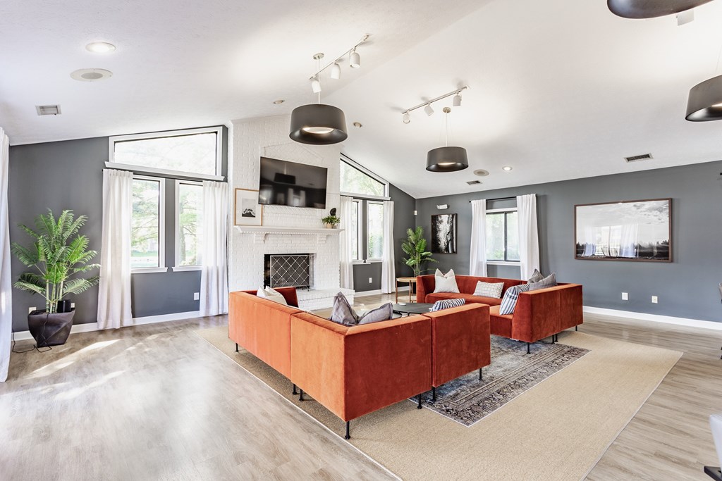 A modern living room with a fireplace and a large couch