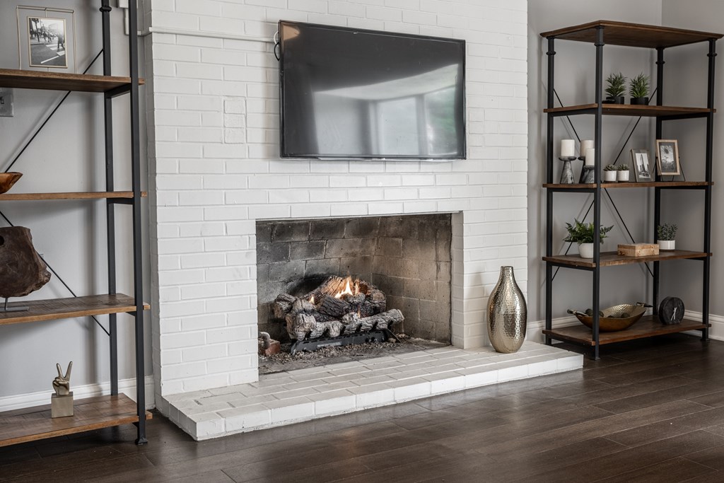 A modern living room with a fireplace and a flat screen TV mounted above it