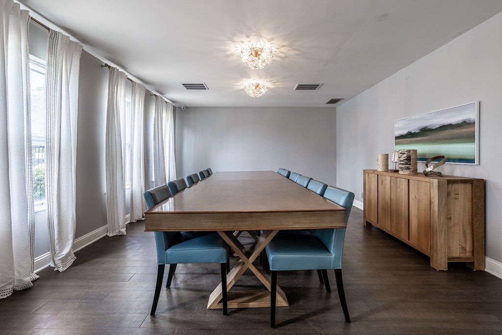 A dining room with a wooden table and blue chairs