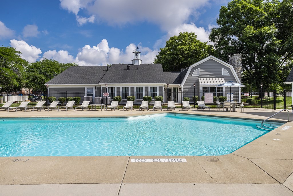 A pool with a building behind it