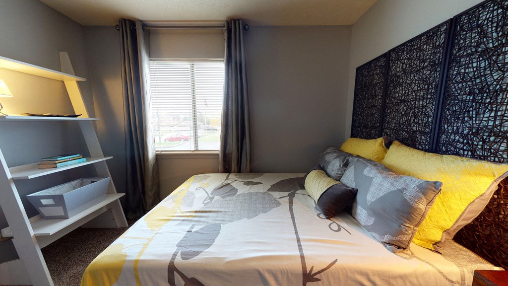 Bedroom with cozy bedat The Timbers Apartments, Evansville, 47715