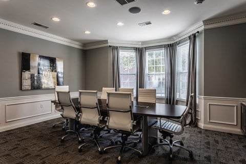 a conference room with a table and chairs and windows at Bella Vista Apartments, Fishers, IN