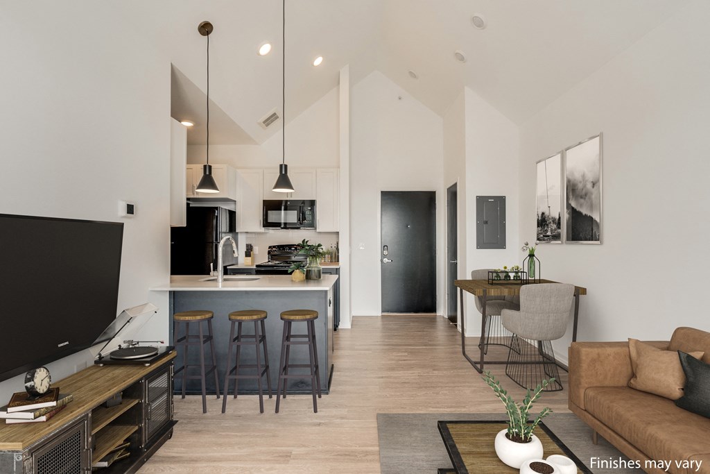 a kitchen and living room with white walls and wood flooring  at Uptown Square Apartments, Troy