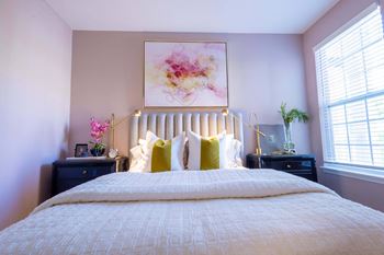 a bedroom with purple walls and a white bed