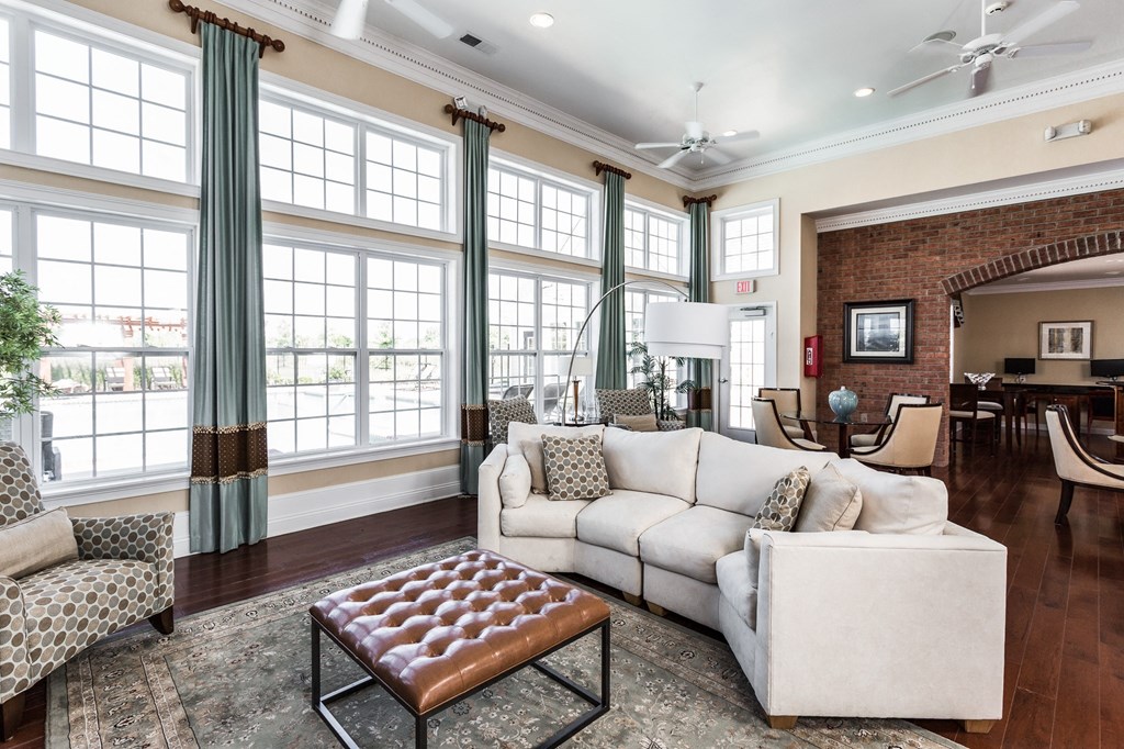 a living room with large windows and a white couch at Brickshire Apartments, Indiana, 46410