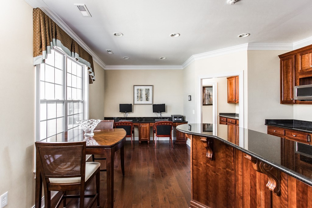 a living room with a kitchen and a dining room at Brickshire Apartments, Merrillville, IN