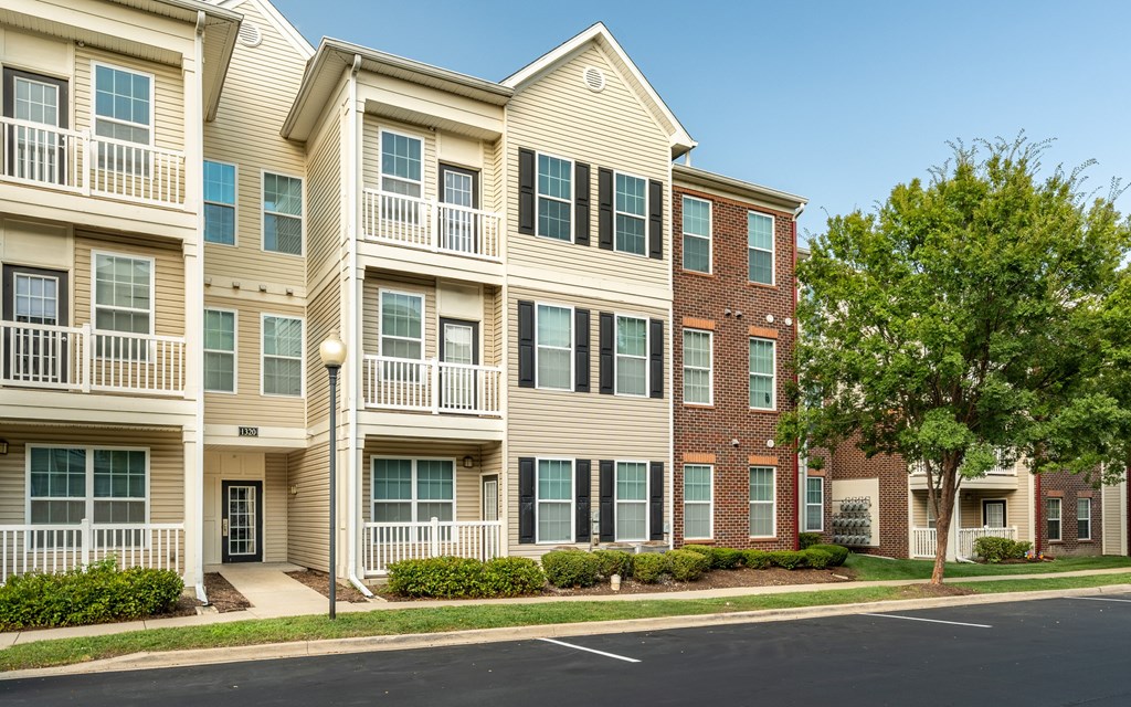 Apartment building with a tree in front of it
