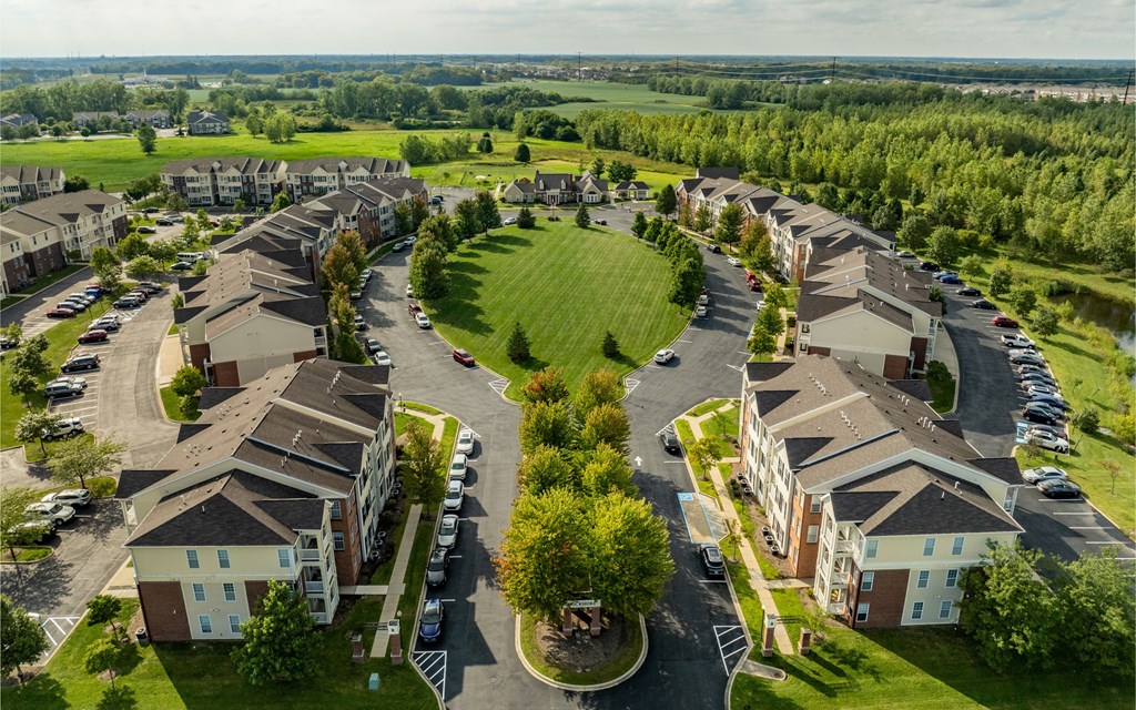 A bird's eye view of a residential area with houses and cars
