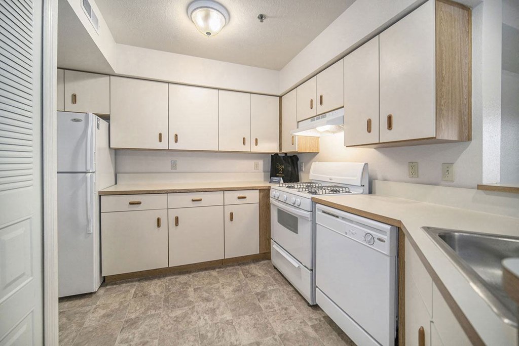 a kitchen with white appliances a kitchen with white appliances at Canal 2 Apartments, Lansing, 48917