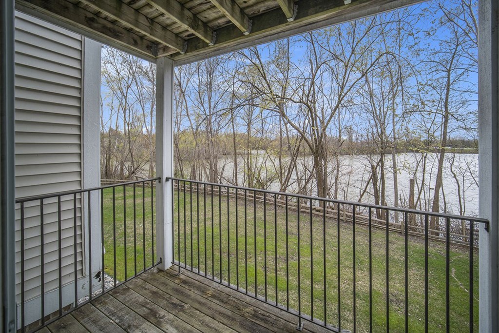 the view from the balcony of an apartment overlooking a pond at Canal 2 Apartments in Lansing, MI