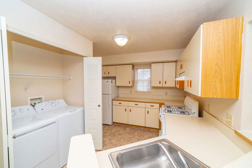 an end kitchen with a washer and dryer at Canal 2 Apartments, Lansing, Michigan