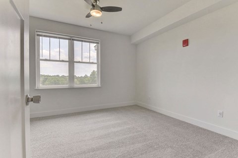 a bedroom with a ceiling fan in at Chase Creek Apartment Homes, Alabama