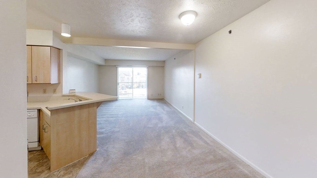 a living room and dining room leading to a kitchen at Colonial Pointe at Fairview Apartments, Bellevue, Nebraska