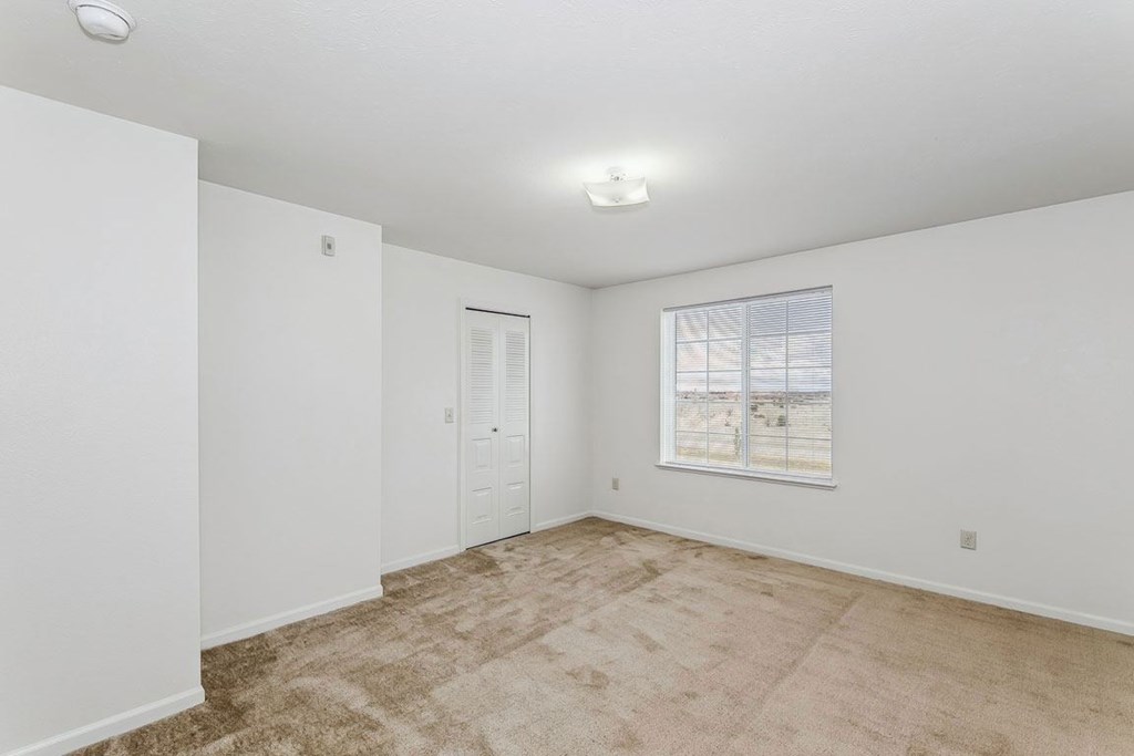 Bedroom with closet and a window at Colonial Pointe at Fairview Apartments, Bellevue, Nebraska