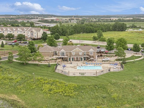 an aerial view of a large house with a pool and yard