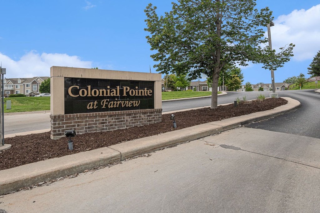 entrance sign for Colonial Pointe at Fairview Apartments in Bellevue, NE