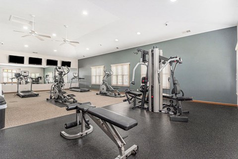 Fitness center with cardio and strength equipment at Colonial Pointe at Fairview Apartments, Bellevue, NE