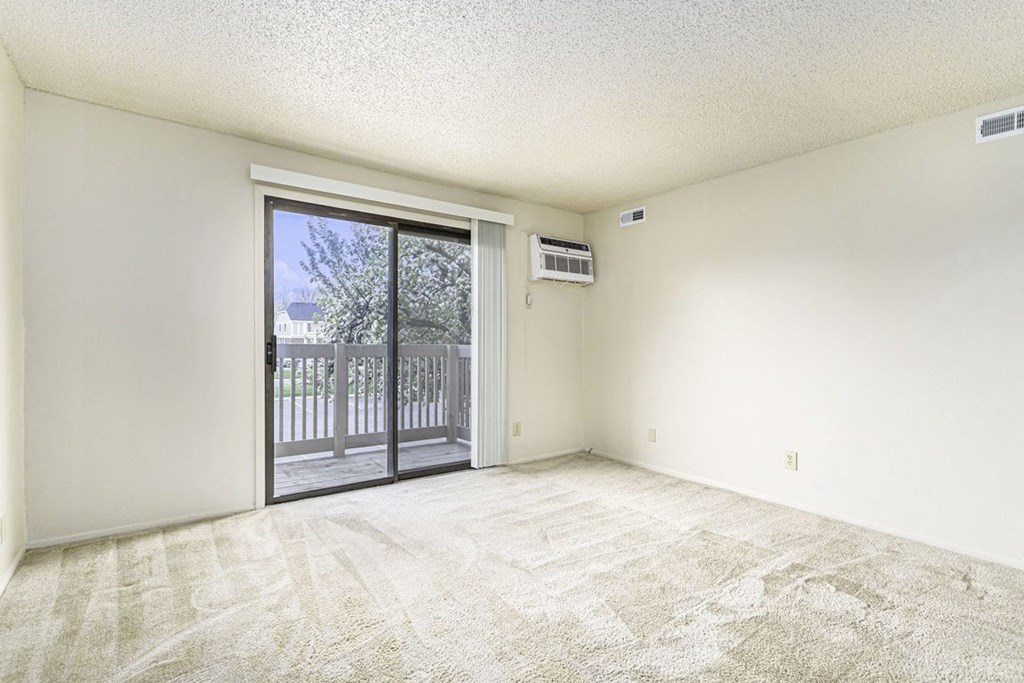 Spacious Living Room Leads To Private Balcony at Concord Place Apartments in Kalamazoo, Michigan 49009