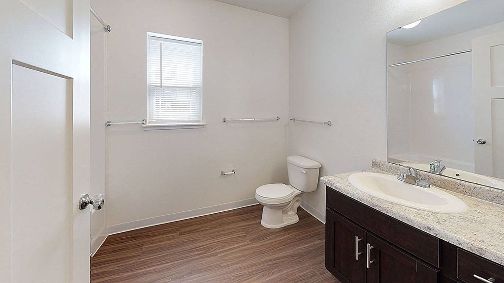 Large bathroom with a window and hard surface flooring at Copper Creek Apartment Homes, Maize, KS