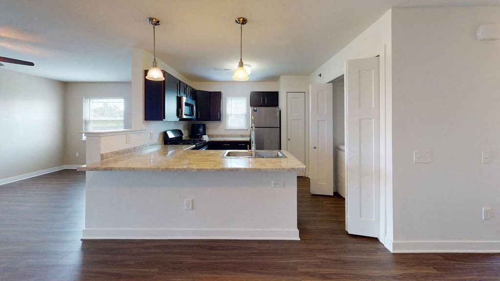End style kitchen and living area at Copper Creek Apartment Homes in KS 67101