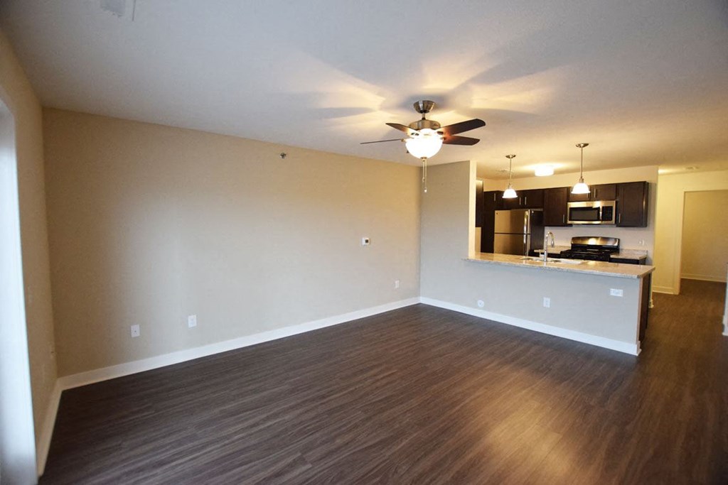 Living room with hard surface flooring at Copper Creek Apartment Homes in Maize, Kansas
