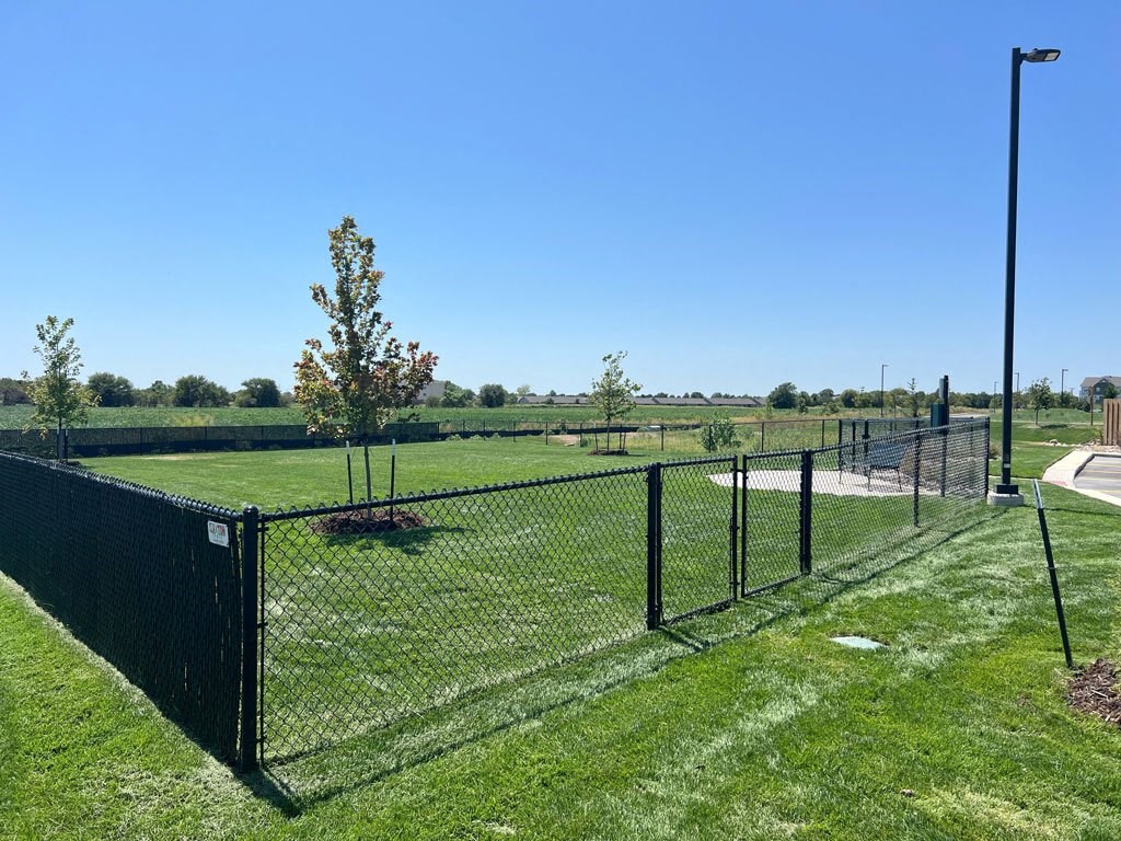 a spacious fenced in dog park at Copper Creek Apartments in Maize, KS