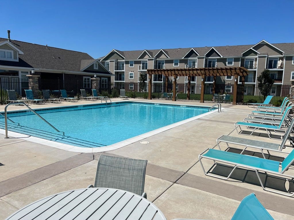 Sparkling Pool beside Community Building at Copper Creek Apartment Homes in Maize, Kansas