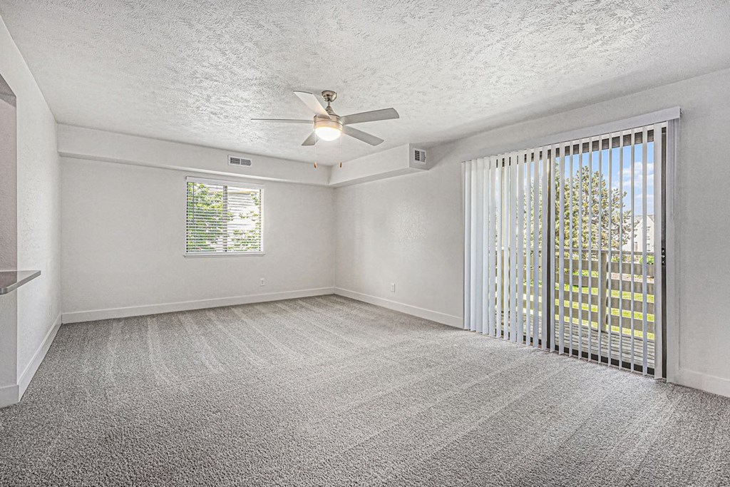 enlarged living room with ceiling fan at The Crossings Apartments, Michigan, 49508