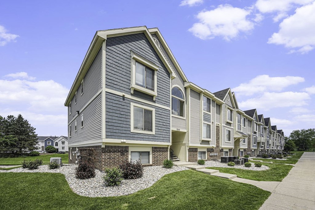 exterior apartment building with green lawn at The Crossings Apartments, Michigan, 49508