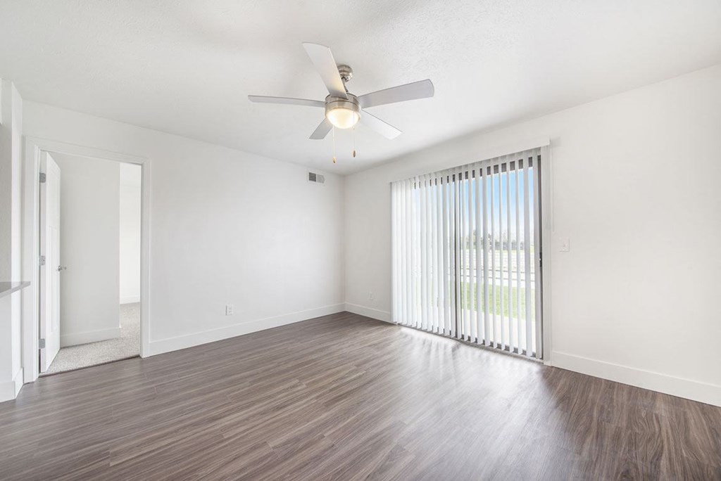 Renovated Living Room Leads To Patio at The Crossings Apartments, Grand Rapids, Michigan