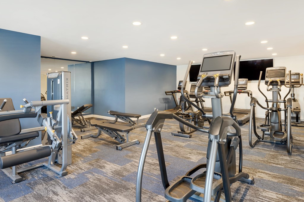 a gym with cardio equipment and weights in a buildingat Sundance Apartments, Indianapolis, IN, 46237