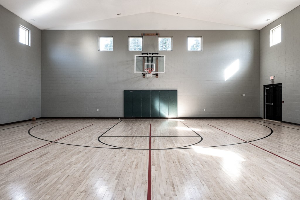 an empty gym with a basketball court and wood floors at Latitudes Apartments, Indianapolis, Indiana