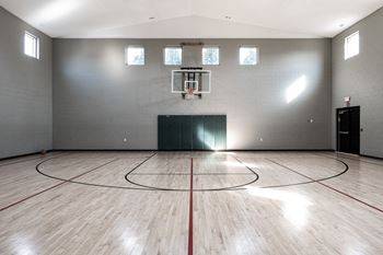 an empty gym with a basketball court and wood floors at Latitudes Apartments, Indianapolis
