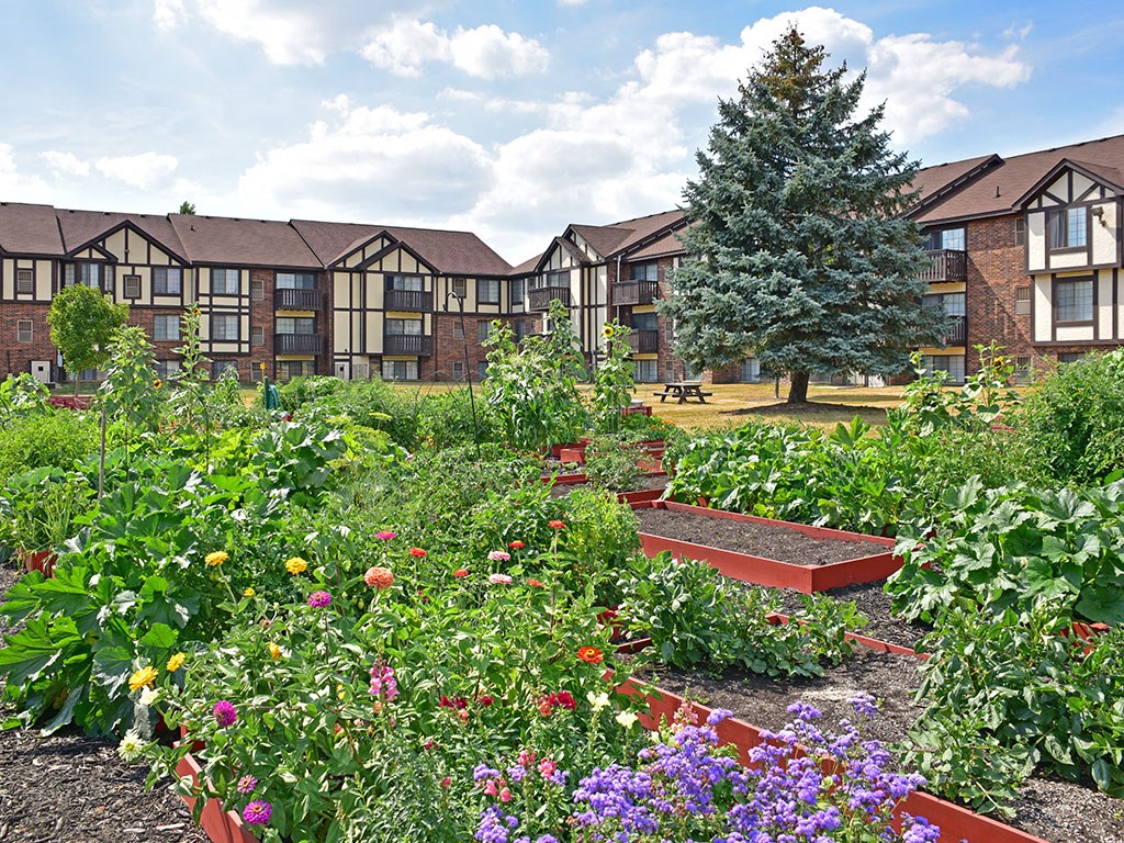 Courtyard Garden With Flowers at Charter Oaks Apartments, Davison, Michigan