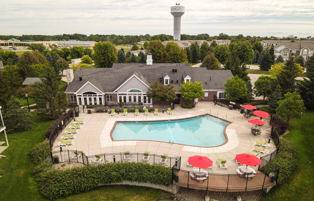 A large building with a pool in front of it.