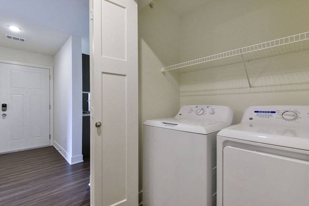 Laundry Room with a Full-Size Washer and Dryer at Dodson Pointe Apartment Homes in Rogers, AR