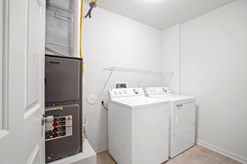 A small laundry room with a washer and dryer.