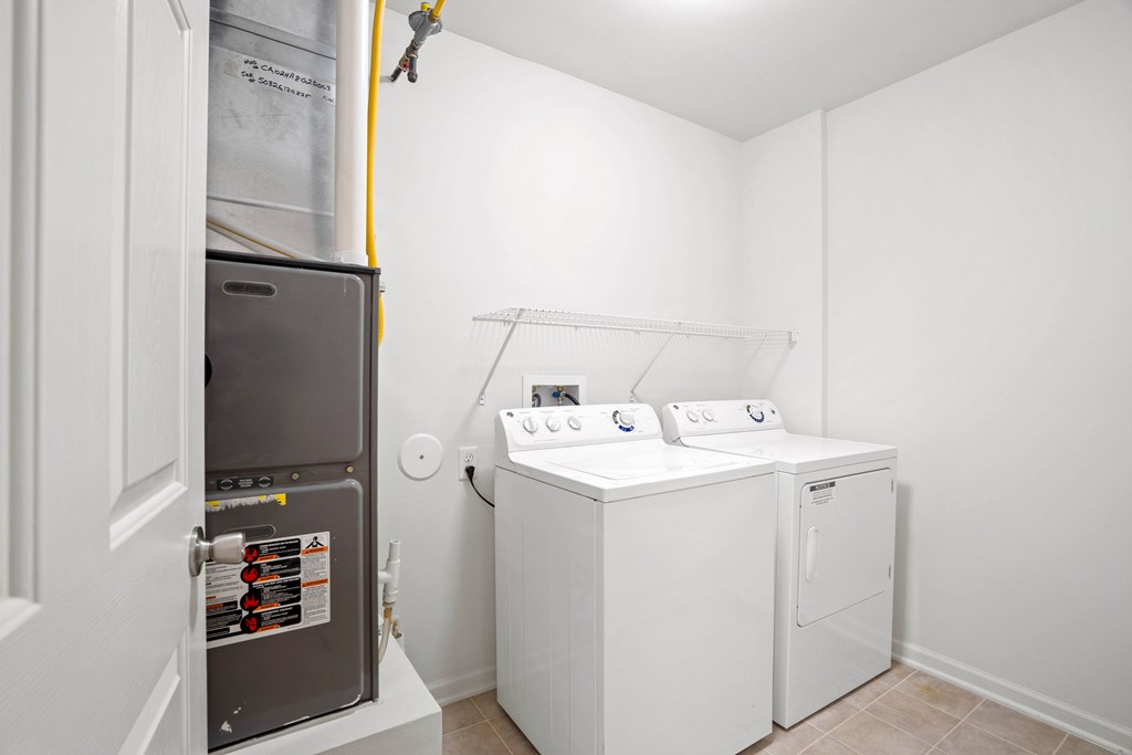 A small laundry room with a washer and dryer.